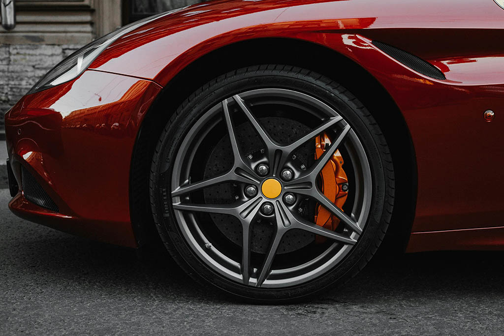 Une voiture rouge avec une jante étoile et un bloc ABS